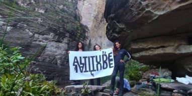Huge waterfall seen from below surrounded by cliffs